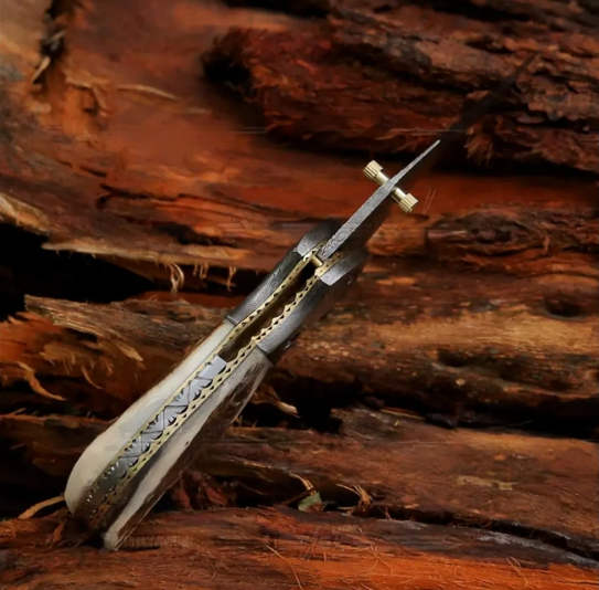 Handmade forged Damascus pocket folding knife featuring a stag antler handle